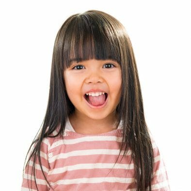 little girl smiling with her tongue out