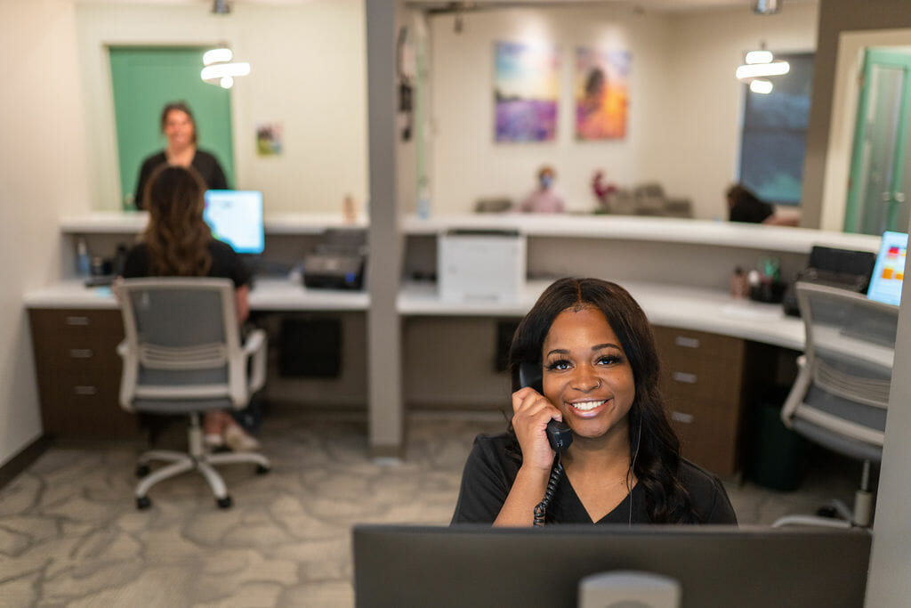 Front desk team member answering phone